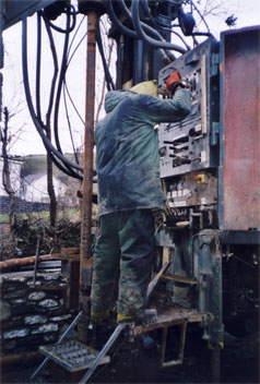 Down goes another drill rod under the watchful eye of our Senior Driller